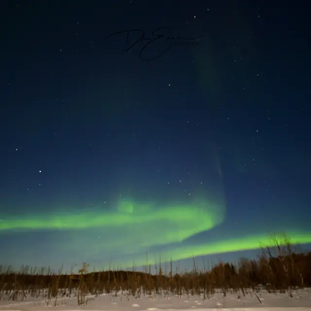 Northern Lights over snowy northern landscape